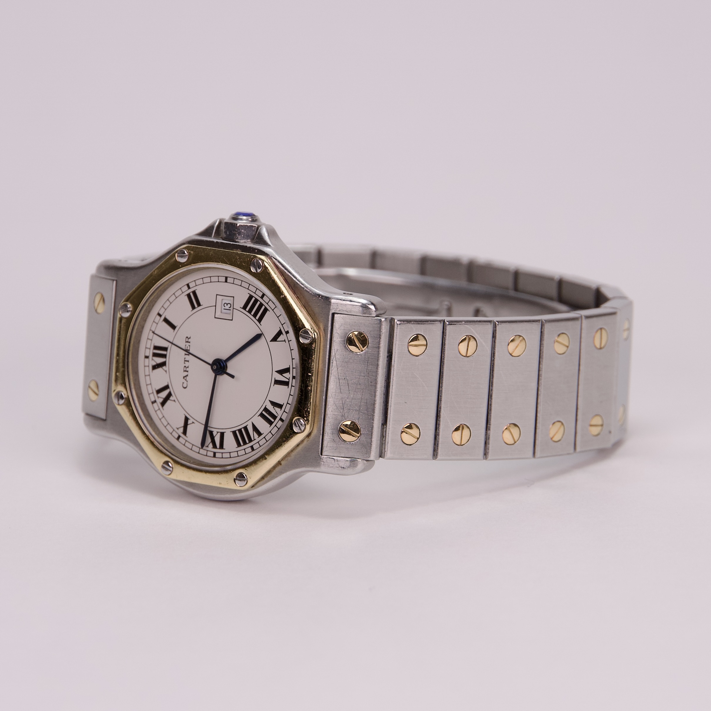 Silver and gold wristwatch with Roman numerals.