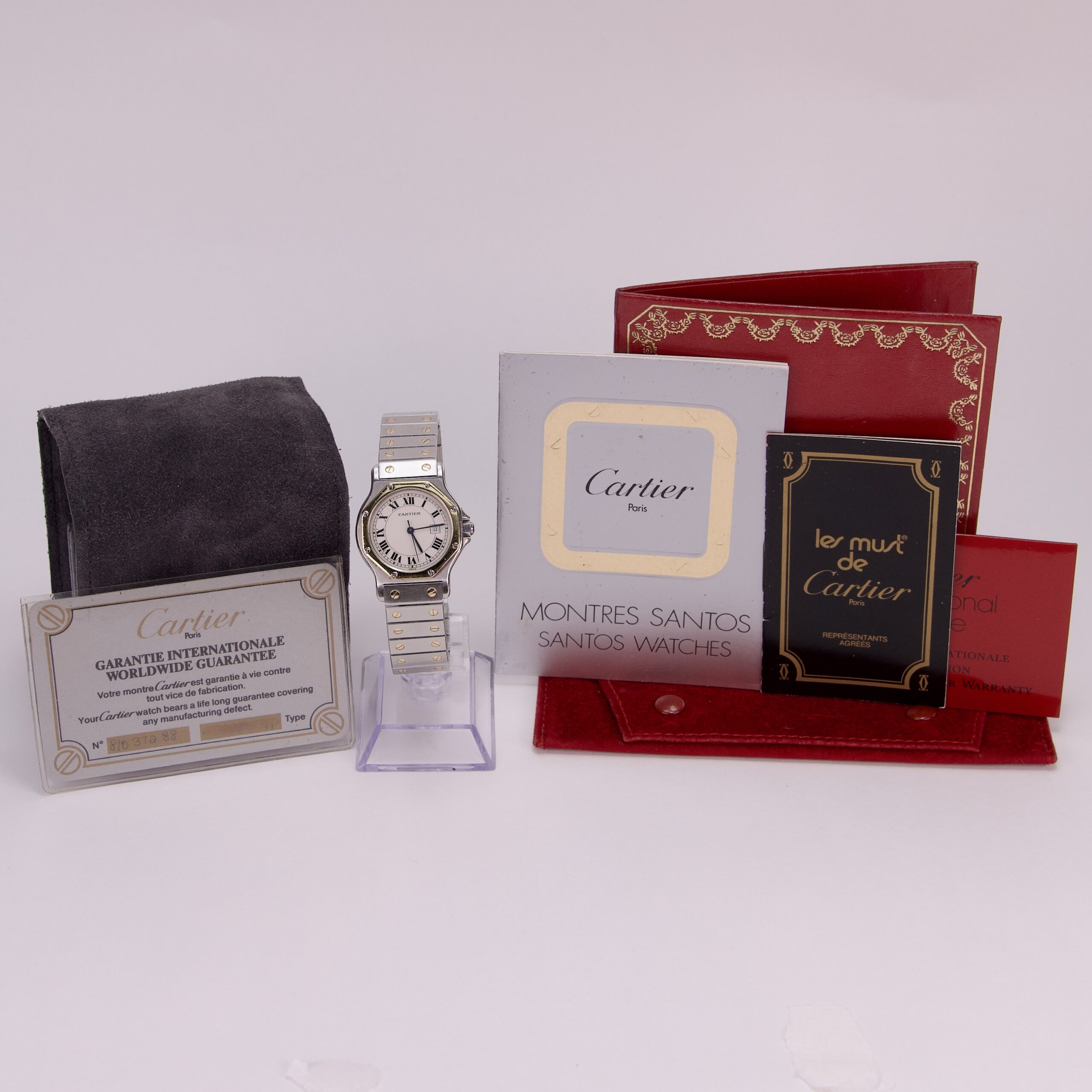 Cartier watch with packaging and documents displayed.