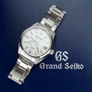 Grand Seiko watch on blue background.