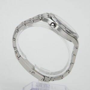 Silver wristwatch with metal strap, side view.