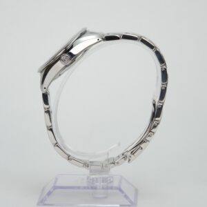 Side view of silver wristwatch on stand.