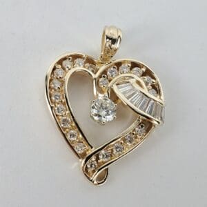 Gold heart-shaped pendant with diamonds.