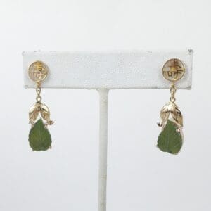 Gold earrings with green leaf pendants.