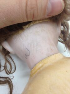 A woman with long hair is holding her head.
