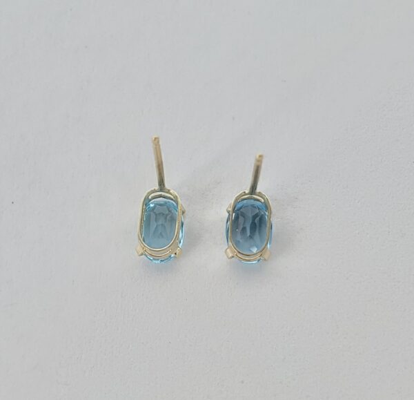 10k Yellow Gold .90ctw Oval Cut Blue Topaz Stud Earrings - Image 5