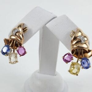 Gold earrings with colorful gemstone accents.